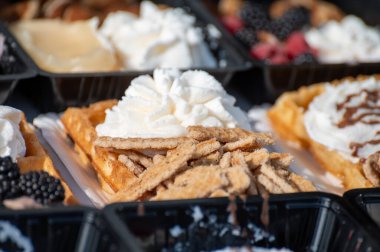 Farklı malzemelerle zenginleştirilmiş taze waffle çeşitleri, tatlı tatlılar, çikolata, krema, meyve ve meyveler, pastanede şekerleme dükkanı, eski Volendam, geleneksel Hollanda tatlıları