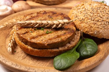 Vejetaryen veya vejetaryen köftelerden hamburgerler yapmak veya tahıldan yapılmış hamburgerler, hayati buğday glüten yemekleri, ızgara sağlıklı yiyecekler.