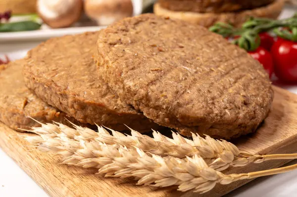 Tahıldan yapılmış yuvarlak vejetaryen köfteler ya da hamburgerler, hayati buğday glüten yiyecekler, pişirilmemiş ve ahşap kalaslarda kızartılmış.