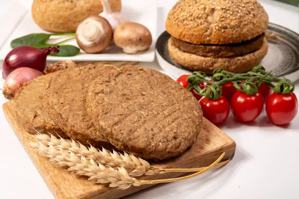 Tahıldan yapılmış yuvarlak vejetaryen köfteler ya da hamburgerler, hayati buğday glüten yiyecekler, pişirilmemiş ve ahşap kalaslarda kızartılmış.