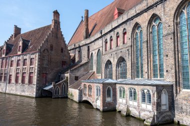 Bruges, Flanders, Belçika 'daki eski ortaçağ binalarının kanalı, köprüsü ve ön cepheleri güneşli bir günde gidilecek yer.