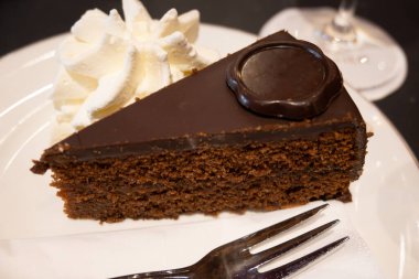 Avusturya kaynaklı kayısı reçelli ünlü Sachertorte çikolatalı keki Viyana 'daki eski klasik kafe restoranında kremayla servis ediliyor.