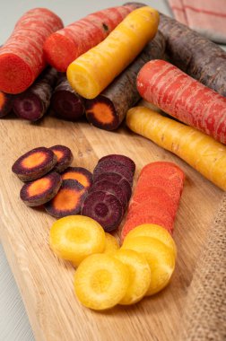 Renkli taze çiğ mor, sarı, kırmızı ve mor turuncu havuç Hollanda 'daki seradan sebze kökü, sağlıklı besin maddeleri.