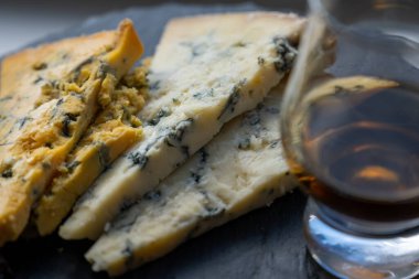 Viski ve peynir eşleştirme, viski bardağı ve tabağı tatma, dilimlenmiş eski mavi stilton ve mavi shropshire peyniri, İngiltere 'nin yiyecek ve içeceği.