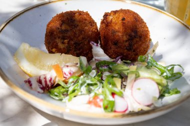Açık kafede öğle yemeği. Vejetaryen peyniri ve yeşil kuşkonmaz kroket yanında taze salata ve Belçika, Bruges 'de patates kızartması.