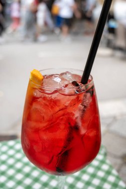 Spritz Campari, likör, şarap, buz küpleri ve bir parça portakal, Palermo, Sicilya, İtalya 'nın sokak manzaralı sert, uzun bir kokteyl kızı.