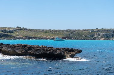 Trapani 'den tekne gezisi ve açık turkuvaz suyu, tuff kayaları, terk edilmiş taş ocakları, Sicilya, İtalya yakınlarındaki Egadi Adaları ile birlikte Favignana adasının kıyı şeridi manzarası.