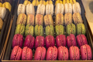 Makaronlar ya da Fransız kurabiyeli tatlı krema şekerli yumurta beyazı, krema şekeri, granüllü şeker, badem yemeği ve gıda boyası sergilenmekte olan tatlı Fransız tatlısı, kapat.