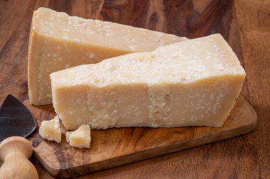 Geleneksel İtalyan yemekleri, 36 aylık mağaralardaki İtalyan parmesan peyniri Parmigiano-Reggiano ve Po River Valley, İtalya 'dan grana padano, yakın çekim.