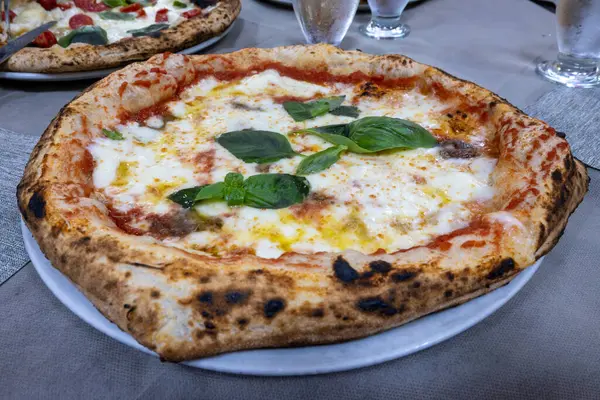 İtalyan pizzacıda fırın fırını, fırın, pizza ve pizza yemek. Kapatın.