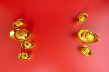 Happy Chinese New Year. Chinese Gold Sycee. Isolated red. Copy space. Usable for wallpaper, greeting card, design.