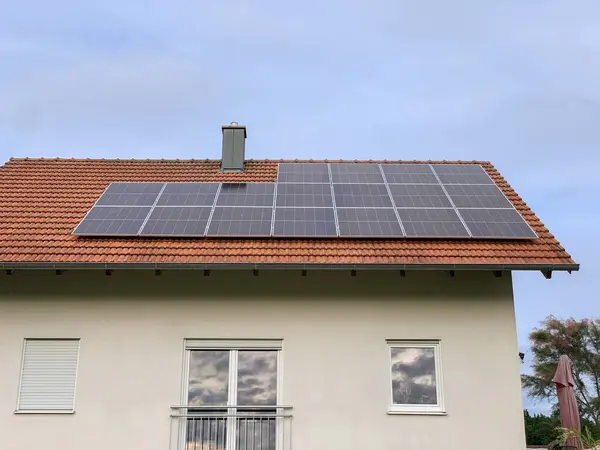 Solar photovoltaic panels on house roof. Modern country house with self-sustaining energy system