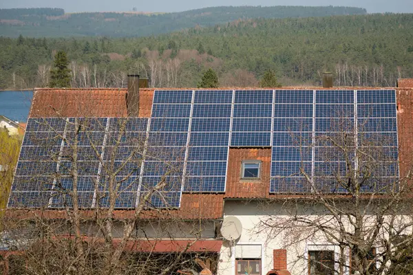 Solar panels on the roof of a house with red tiles