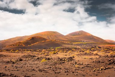 Wild volcanic landscape of Los Volcanes Natural Park in Lanzarote, Canary Islands, Spain