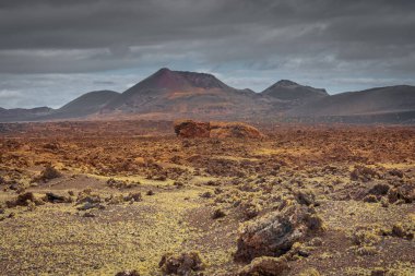 Wild volcanic landscape of Los Volcanes Natural Park in Lanzarote, Canary Islands, Spain