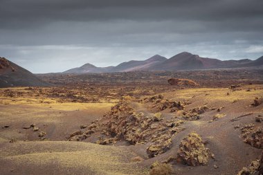 Wild volcanic landscape of Los Volcanes Natural Park in Lanzarote, Canary Islands, Spain