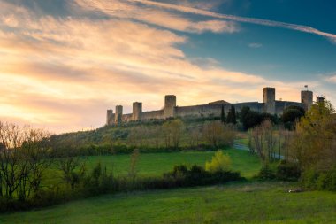 Sunset over the medieval fortified town of Monteriggioni, Tuscany, Italy