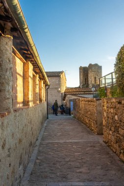 Monteriggioni, Italy, 17 April 2022: historic center of the medieval town at sunset