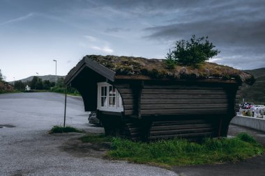 Eidfjord, Norway, 8 August 2022: Wooden peat house with grass roof