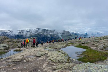 Odda, Norway, 8 August 2022: Long queue to get a photo over Trolltunga, the famous tourist spot