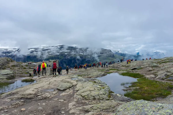 stock image Odda, Norway, 8 August 2022: Long queue to get a photo over Trolltunga, the famous tourist spot