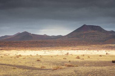 Wild volcanic landscape of Los Volcanes Natural Park in Lanzarote, Canary Islands, Spain