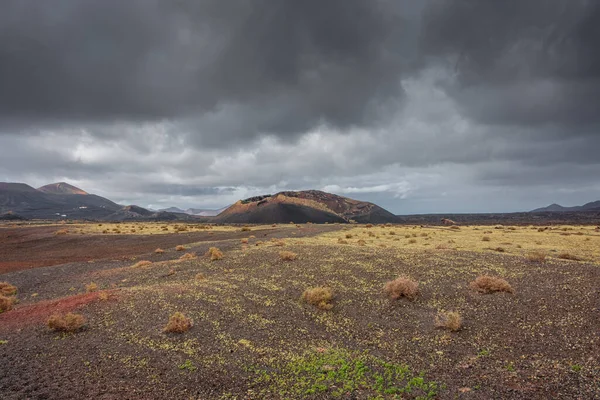 Wild volcanic landscape of Los Volcanes Natural Park in Lanzarote, Canary Islands, Spain