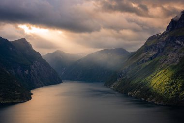 Dramatic sunbeam from the clouds over the Geirangerfjord, Norway