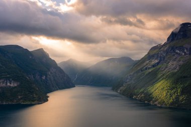 Dramatic sunbeam from the clouds over the Geirangerfjord, Norway