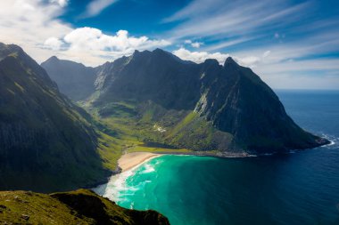 View over the turquoise water of Kvalvika Beach from Ryten Mount, Lofoten Islands, Norway