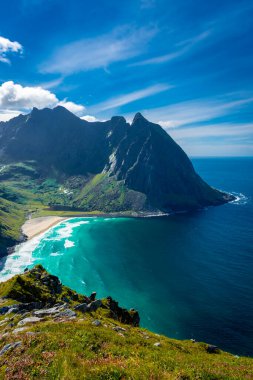 View over the turquoise water of Kvalvika Beach from Ryten Mount, Lofoten Islands, Norway