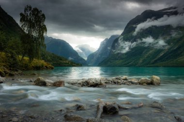 Landscape of the Lovatnet glacial lake with turquoise crystal clear water, Norway