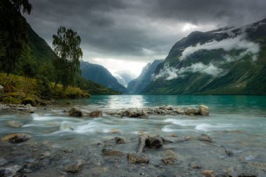 Landscape of the Lovatnet glacial lake with turquoise crystal clear water, Norway