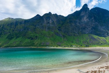 The crystal clear water of the Ersfjordstranda beach in Senja Island, Norway