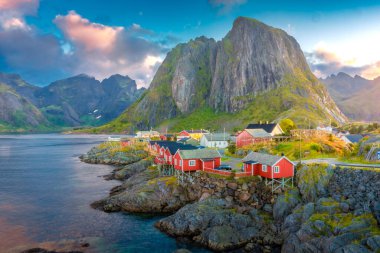 Beautiful sunrise over Hamnoy, fishermen village with the typical red houses of the Lofoten Islands, Norway