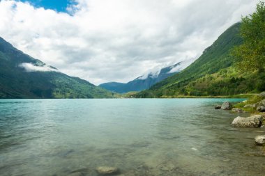 Landscape of the Lovatnet glacial lake with turquoise crystal clear water, Norway
