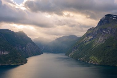 Dramatic sunbeam from the clouds over the Geirangerfjord, Norway