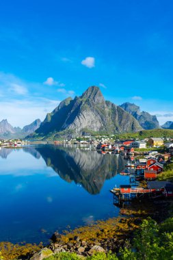 Perfect reflection of the Reine village on the water of the fjord in the Lofoten Islands, Norway