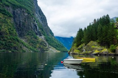 Moody landscape with boats in the Naeroyfjord from Gudvangen, Norway