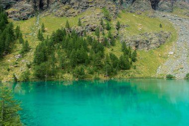 The crystal clear water of the Blue Lake of Ayes, Italian Alps