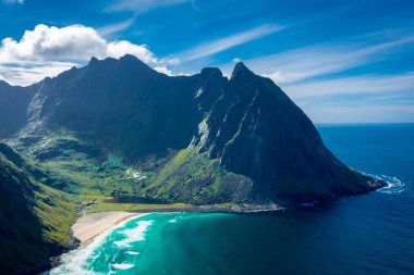 View over the turquoise water of Kvalvika Beach from Ryten Mount, Lofoten Islands, Norway