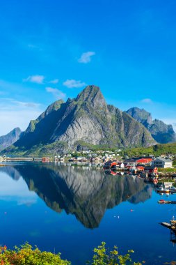 Perfect reflection of the Reine village on the water of the fjord in the Lofoten Islands, Norway