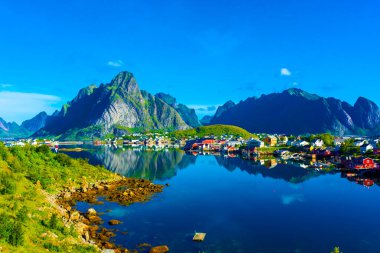 Perfect reflection of the Reine village on the water of the fjord in the Lofoten Islands, Norway