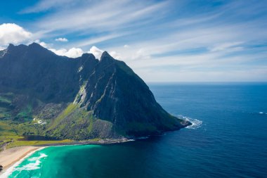View over the turquoise water of Kvalvika Beach from Ryten Mount, Lofoten Islands, Norway