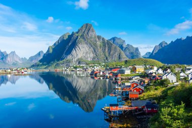 Perfect reflection of the Reine village on the water of the fjord in the Lofoten Islands, Norway