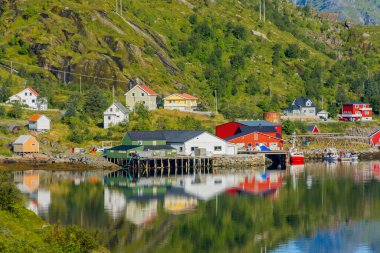 Perfect reflection of the Reine village on the water of the fjord in the Lofoten Islands, Norway