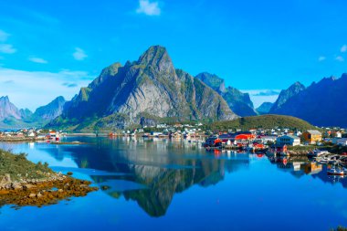 Perfect reflection of the Reine village on the water of the fjord in the Lofoten Islands, Norway