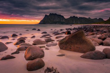 Dramatic midnight sunset with amazing colors over Uttakleiv beach on Lofoten Islands, Norway