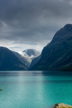 Landscape of the Lovatnet glacial lake with turquoise crystal clear water, Norway