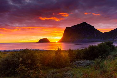 Incredible midnight sunset over the sea of Vik beach, Lofoten Islands, Norway